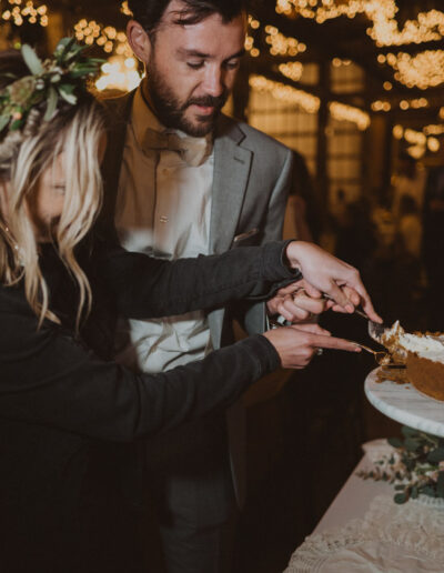 Bride and Groom cutting the cake by McKenzie Shea Photography